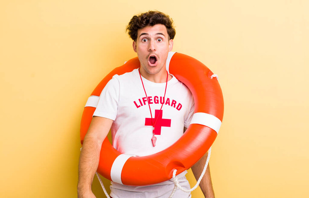 young handsome guy looking very shocked or surprised. lifeguard concept - Photo, Image