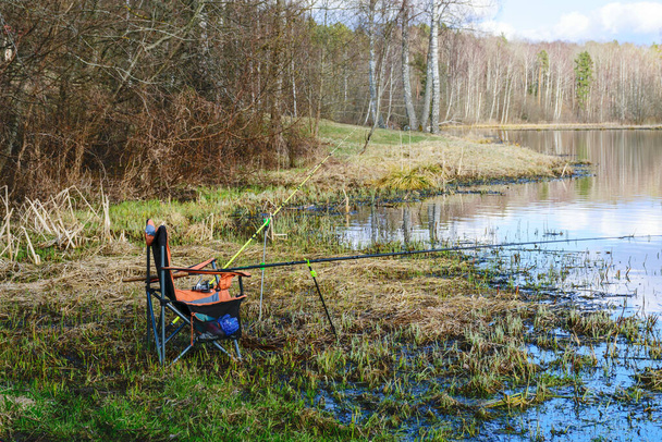 https://cdn.create.vista.com/api/media/small/576157706/stock-photo-beautiful-landscape-fishing-chair-lake-shore-fishing-equipment-fishing-rods