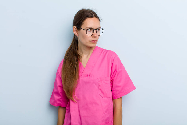 young adult woman feeling sad, upset or angry and looking to the side. nurse concept - Fotografie, Obrázek