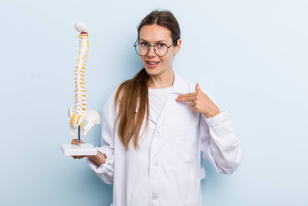 young adult woman feeling happy and pointing to self with an excited. spine specialist concept - Foto, afbeelding
