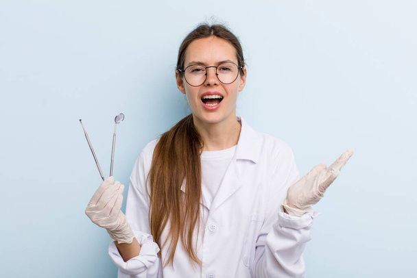 young adult woman looking desperate, frustrated and stressed. dentist concept - Photo, Image