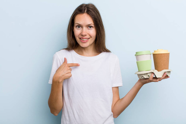 young adult woman feeling happy and pointing to self with an excited. take away coffee concept - Photo, Image