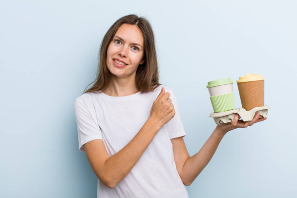 young adult woman feeling happy and facing a challenge or celebrating. take away coffee concept - Photo, Image