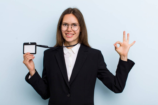 young adult woman feeling happy, showing approval with okay gesture. vip pass id concept - Фото, зображення