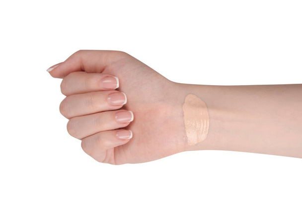 Swatch of foundation on a woman hand isolated on a white background. - Foto, Imagem
