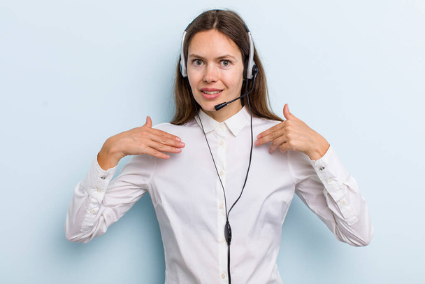 young adult woman feeling happy and pointing to self with an excited. telemarketer concept - 写真・画像