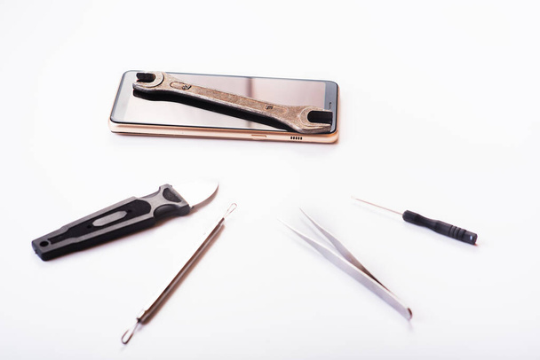 Flat lay image of dismantling the broken smart phone for preparing to repair or replace some components on the white background. repairing a damaged mobile phone. isolated. Top view - Foto, Imagen