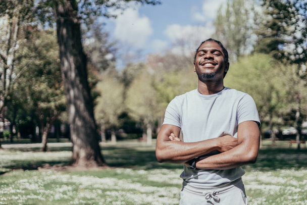 Portrait of fashionable african american fitness man in park - Photo, Image