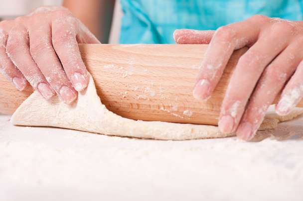 Woman hands mixing dough on the table - Photo, image