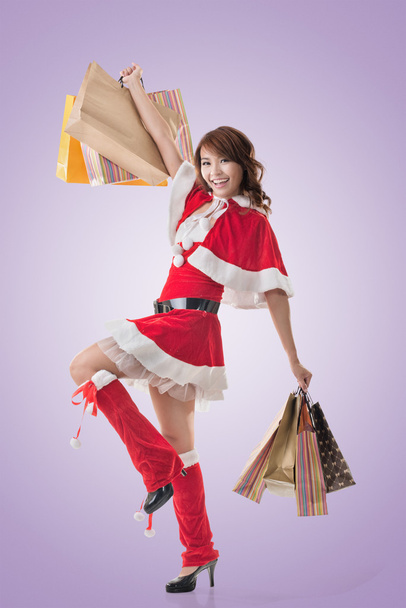 Asian Christmas girl hold shopping bags - 写真・画像