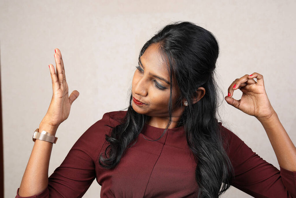 Asian Indian origin dark skin tone beautiful woman facial hand expression making faces hand signs - Foto, afbeelding