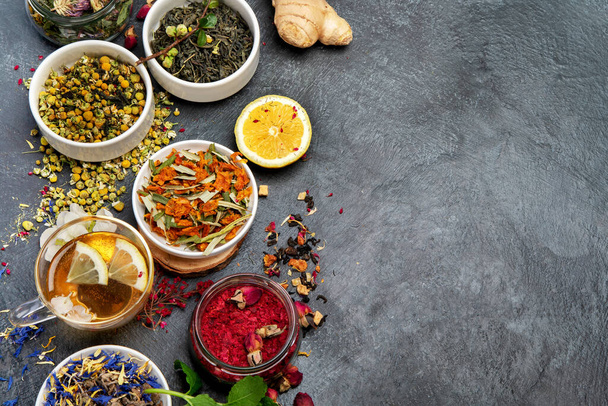 Herbal tea assortment on dark background. Traditional healthcare remedies. Top view, flat lay, copy space - Fotó, kép