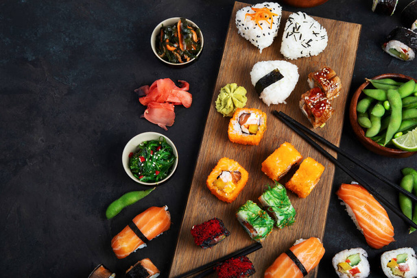 Japanese food assortment on dark background. Traditional food concept. Dishes and appetizers of indeed cuisine. Top view, copy space, flat lay - 写真・画像