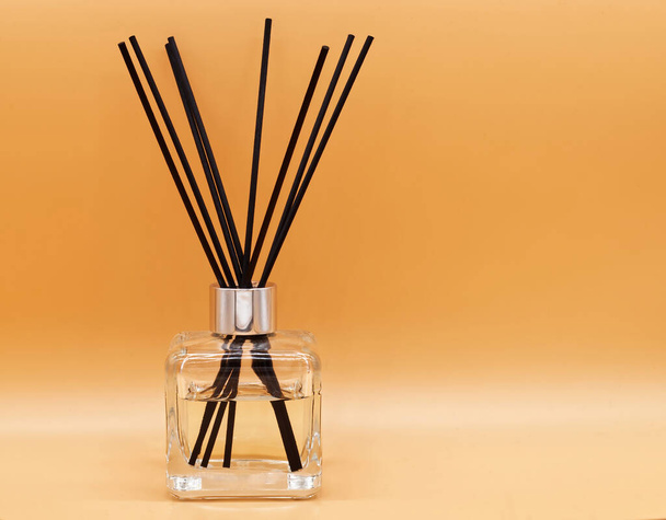 Air freshener sticks isolated on beige background. Aroma sticks and essential oil bottle for relaxation - Foto, immagini