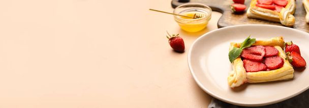 Plate with sweet strawberry puff pastry on light color background with space for text - Foto, Imagem