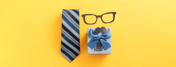 Father's day gift background design concept with gift box idea and necktie on yellow background. - Foto, Imagem