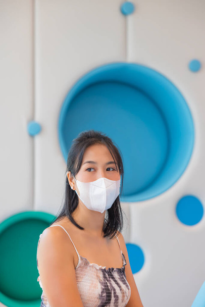Close-up woman wearing face mask because Air pollution, virus epidemic, flu. Young elegant happy Asian woman put on protective. - Valokuva, kuva
