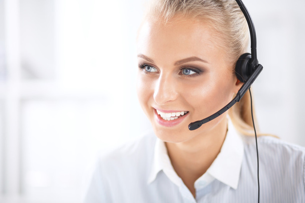 Close-up portrait of a customer service agent sitting at office - Zdjęcie, obraz