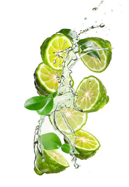 Fresh ripe bergamot fruits, green leaves and splashing water on white background - Фото, зображення