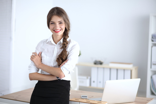 Attractive businesswoman with her arms crossed  standing in office - Φωτογραφία, εικόνα