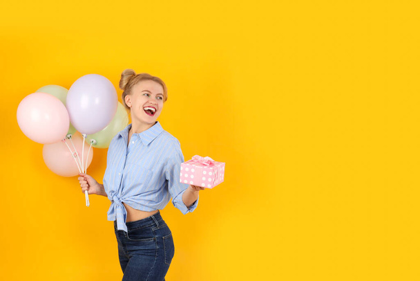 Concept of Happy Birthday with attractive girl on yellow background - Fotoğraf, Görsel