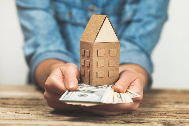Money and a house in hand. Pledge for real estate, rental income. Home sales taxes. - Fotoğraf, Görsel