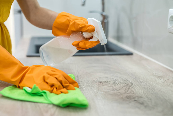 mooie drukke huisvrouw hard werken in de keuken, schoon en desinfectie concept - Foto, afbeelding