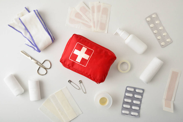 Assortment of emergency first aid kit on white table. Horizontal composition. Top view.  - Фото, зображення
