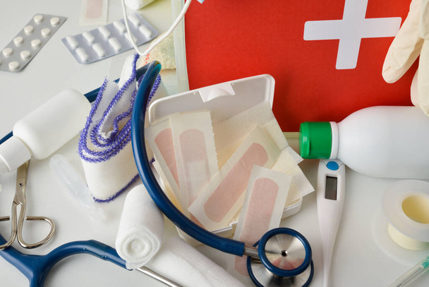 Hospital  assortment of basic first aid portable medical assistance equipment on white table. Horizontal composition. Elevated view.  - Fotoğraf, Görsel