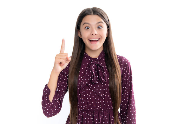 Portrait of emotional amazed excited teen girl. Confident and successful young teenager child over isolated white background showing and pointing up with finger number one. Kid have an good idea - Foto, imagen