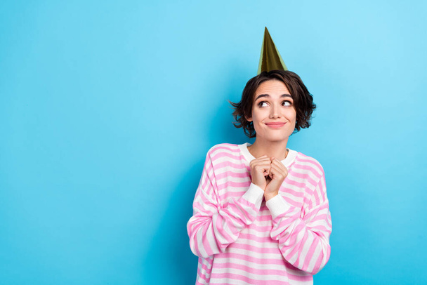 Portrait of adorable young cheerful birthday girl waiting present surprise look empty space isolated on blue color background. - 写真・画像