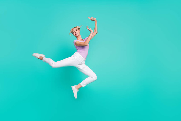Full length body size view of attractive cheerful thin girl jumping dancing training isolated over teal turquoise color background. - Foto, Bild
