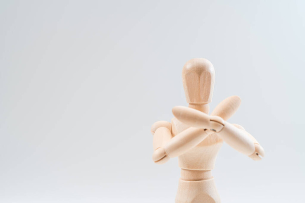 Refusal gesture, Wooden dummy, crossed hands on white background, copy space for your object or text - Photo, Image