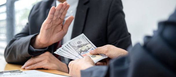 Businessman is refuses to accept banknote money and terms of contract from bribe employer in signing contract while making corruption about buy land and real estate - Photo, image