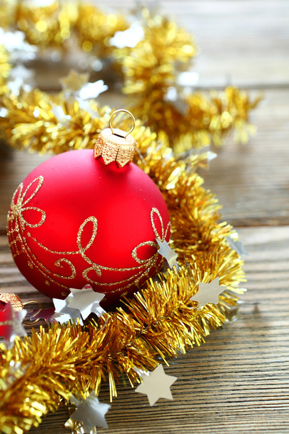 Christmas balls with tinsel on a wooden boards - Photo, image