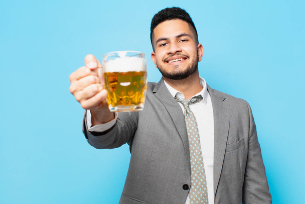 hispanic businessman happy expression and holding a beer - Valokuva, kuva