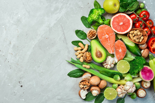 Ketogenic low carbs diet concept. Diet for the heart and blood vessels: nuts, salmon, avocado, spinach, mushrooms, berries. On a stone background. Top view. Copy space. - Foto, Imagem