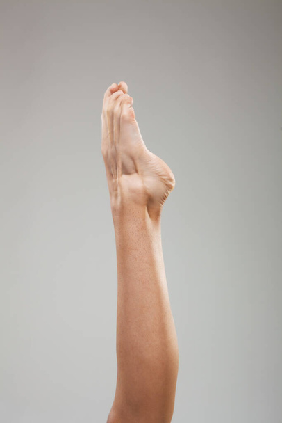 Sexy female legs against gray background. - Φωτογραφία, εικόνα