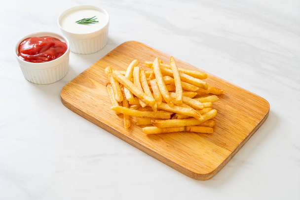 French fries or potato chips with sour cream and ketchup - Valokuva, kuva
