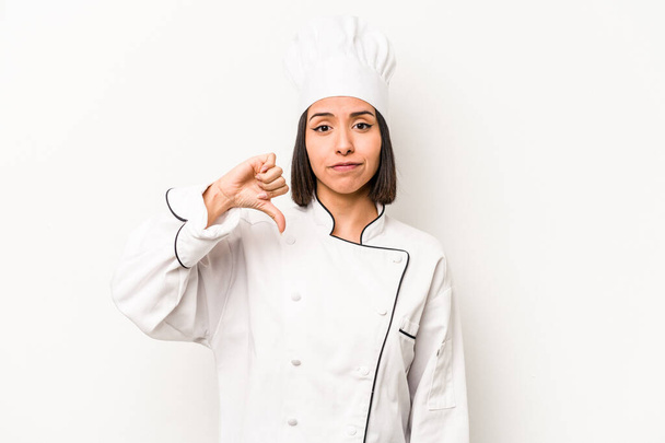 Young hispanic chef woman isolated on white background showing a dislike gesture, thumbs down. Disagreement concept. - Zdjęcie, obraz