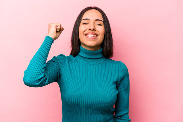 Young hispanic woman isolated on pink background celebrating a victory, passion and enthusiasm, happy expression. - Zdjęcie, obraz