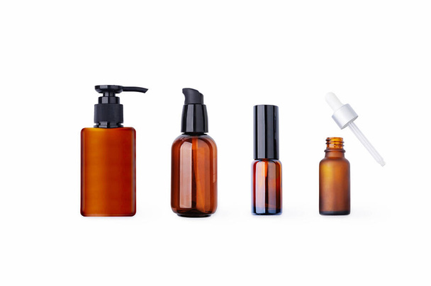Amber cosmetic bottle, dropper and dispenser isolated on white background. Blank label for branding mock-up - Photo, Image
