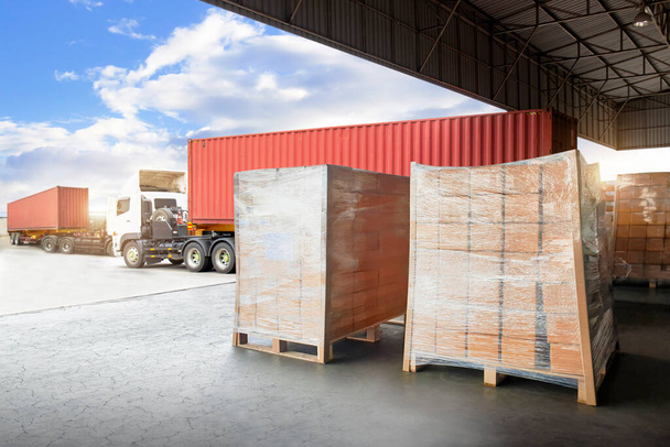 Packaging Boxes Wrapped Plastic on Pallets Loading into Cargo Container. Loading Dock Shipping Trucks. Supply Chain. Shipment Boxes. Distribution Warehouse Freight Truck Transport Logistics - Photo, Image