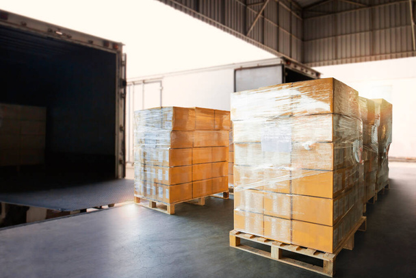Packaging Boxes Wrapped Plastic on Pallets Loading into Cargo Container. Shipping Trucks. Supply Chain. Shipment Boxes. Distribution Warehouse Freight Truck Transport Logistics. - Photo, Image