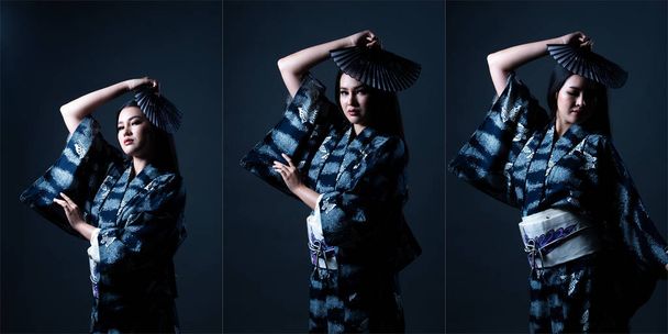 Половина тела 20-летних молодых азиатских женщин носит японское кимоно Yuzha, сильное чувство стресса. Девушка снимается в студии с левым боковым освещением на темном фоне - Фото, изображение