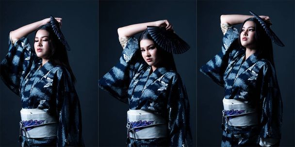 Fashion Half body of 20s young adult Asian Woman wear Japanese Kimono Yukata, strong stress feeling. Beautiful female shoot in studio with left side lighting over dark gray background isolated - Photo, Image