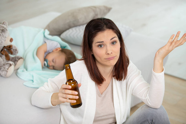 mum drinking beer while baby is sleeping baby - Photo, image