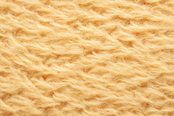 黄色のふわふわの毛皮の生地ウールの質感の背景 - 写真・画像