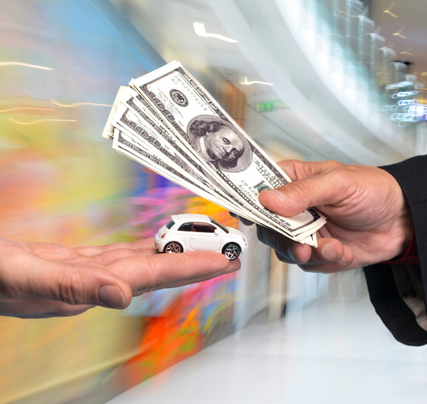 Man holding small car,another man holding dollar bills - Photo, Image