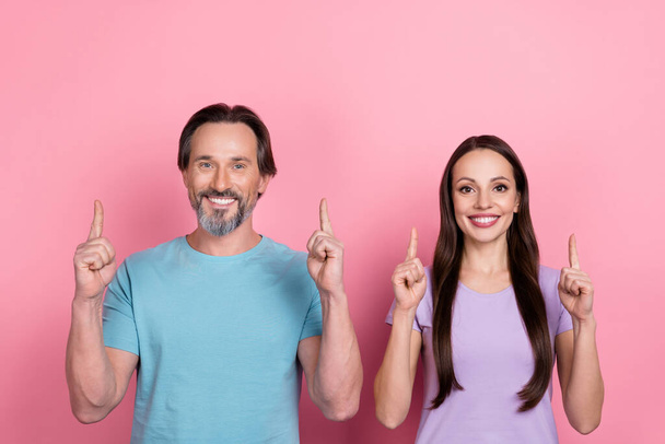 Photo of positive married couple promote black friday shopping sales advert isolated on pink color background. - Φωτογραφία, εικόνα